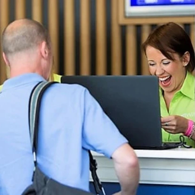 A lady smiling behind a desk