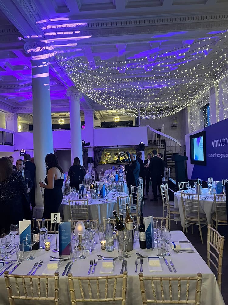 An event with dinner tables and people in the background