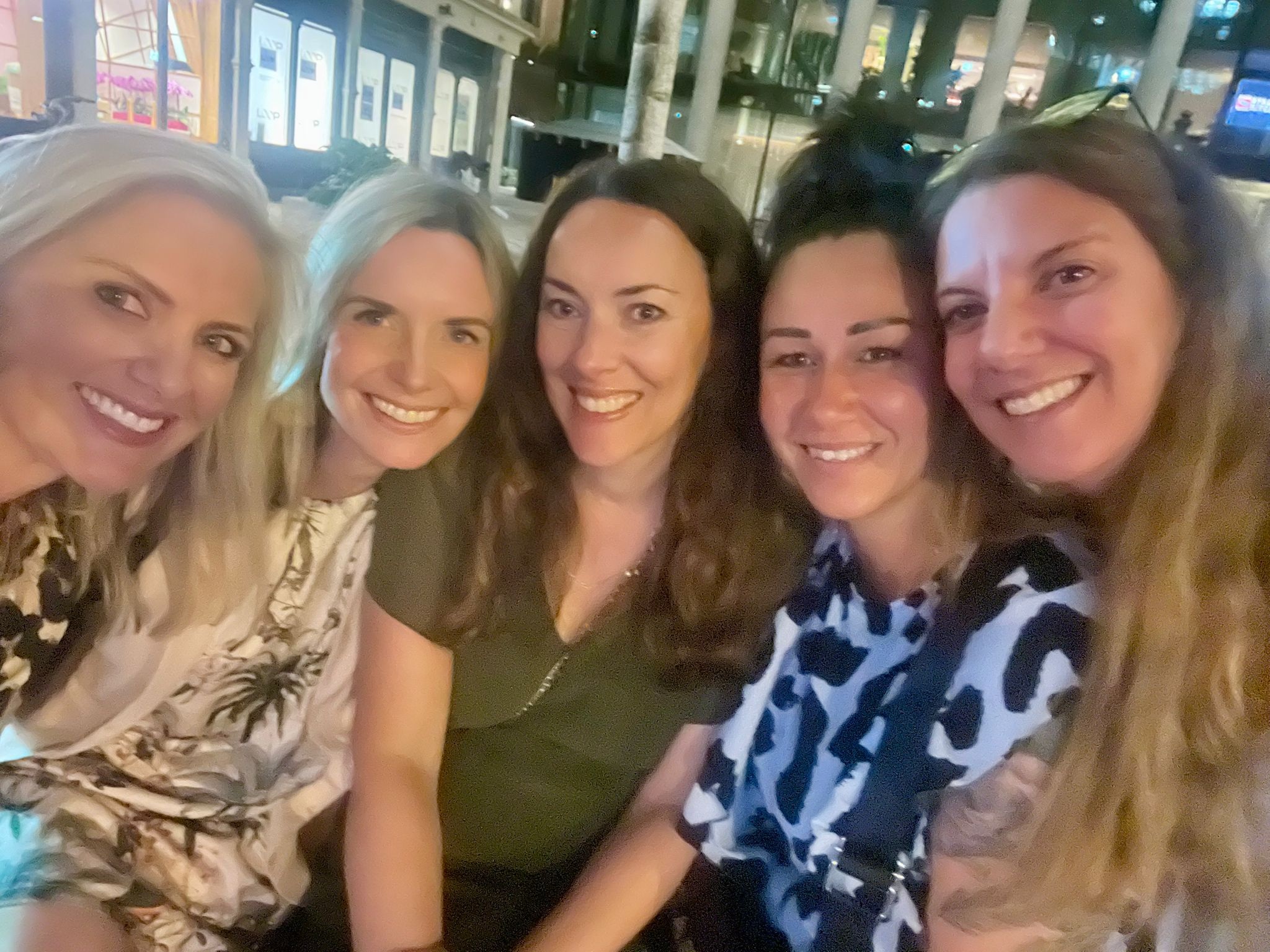 A group of 5 team members smiling