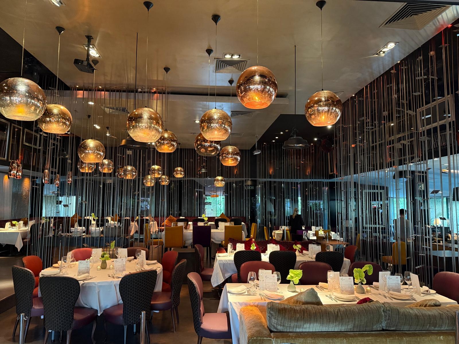 Dining tables underneath hanging lights