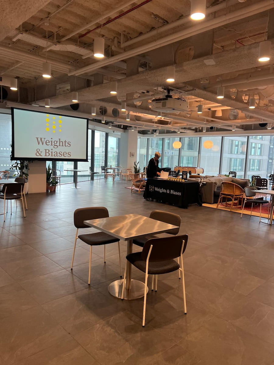 Table in the middle of a room with screen in front