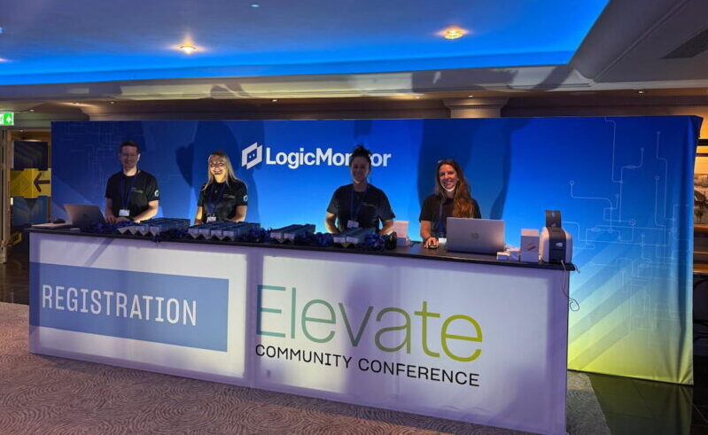 Four people behind a table at event
